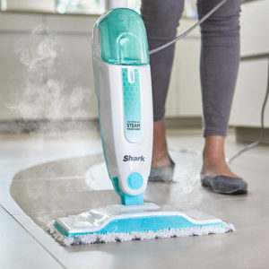Steam mop in action cleaning tile floor