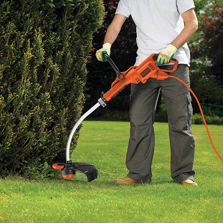  A corded electric strimmer being used