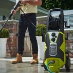 Man using electric pressure washer