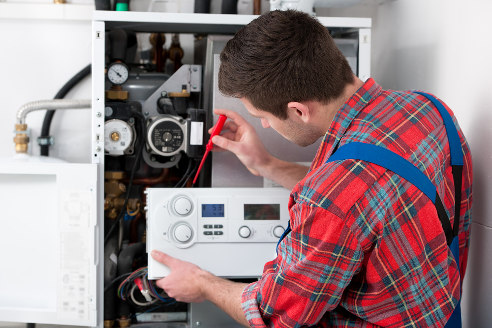 A technician checking pressure of domestic boiler
