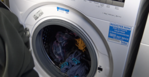 Beko Washing Machine with door open and dirty clothes
